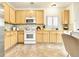 Bright kitchen with wood cabinets, tile floors, and stainless steel appliances at 19691 E 59Th Dr, Aurora, CO 80019