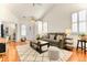 Open-concept living room with vaulted ceilings, hardwood floors, neutral decor, and bright natural light at 19691 E 59Th Dr, Aurora, CO 80019