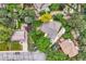 Bird's-eye view of a well-maintained home, showcasing its manicured lawn, garden, patio, and detached garage with mature trees at 2473 S Carr Ct, Lakewood, CO 80227