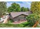 Aerial view of home showing mature trees, lush lawn, and a brick exterior at 2473 S Carr Ct, Lakewood, CO 80227