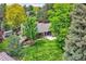 Lush backyard oasis featuring a patio, mature trees, and expansive lawn at 2473 S Carr Ct, Lakewood, CO 80227