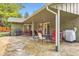 Inviting covered back patio with flagstone flooring, outdoor seating, and a grill, perfect for entertaining at 2473 S Carr Ct, Lakewood, CO 80227
