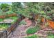 Multi-level backyard featuring landscaping, a wooden fence, and a small gazebo at 2473 S Carr Ct, Lakewood, CO 80227