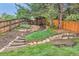 Picturesque backyard with landscaped levels, stone accents, and a cozy gazebo at 2473 S Carr Ct, Lakewood, CO 80227