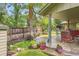 A serene backyard featuring a stone patio, lush landscaping, bird bath, and mature trees, creating a peaceful retreat at 2473 S Carr Ct, Lakewood, CO 80227