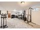 Finished basement featuring an exercise area, desk, and good lighting at 2473 S Carr Ct, Lakewood, CO 80227