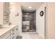 Updated bathroom with walk-in shower and sleek vanity with dual sinks at 2473 S Carr Ct, Lakewood, CO 80227