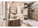 Charming bathroom featuring a stone sink, custom vanity, and tiled shower/bath at 2473 S Carr Ct, Lakewood, CO 80227