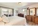 Sunlit bedroom featuring wood floors, neutral walls, and access to a private patio at 2473 S Carr Ct, Lakewood, CO 80227