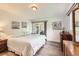 Bright bedroom with wood-look floors and slider to the outside patio at 2473 S Carr Ct, Lakewood, CO 80227