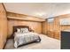 Cozy bedroom with wood paneling, a comfortable bed, and ample natural light at 2473 S Carr Ct, Lakewood, CO 80227