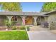 Inviting front porch with brick accents, arched windows, and an American flag at 2473 S Carr Ct, Lakewood, CO 80227