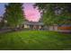 Charming single-story home with lush front lawn and mature trees at 2473 S Carr Ct, Lakewood, CO 80227