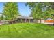 Charming single-story home with lush front lawn and mature trees at 2473 S Carr Ct, Lakewood, CO 80227