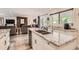 Modern kitchen with granite countertops and stainless steel sink open to the living room at 2473 S Carr Ct, Lakewood, CO 80227