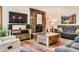 Cozy living room with stone fireplace, comfortable seating, and natural light at 2473 S Carr Ct, Lakewood, CO 80227