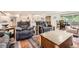 Open-concept living area with comfortable seating and a view of the modern kitchen at 2473 S Carr Ct, Lakewood, CO 80227