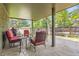 Covered patio with outdoor seating, offering a relaxing view of the backyard at 2473 S Carr Ct, Lakewood, CO 80227