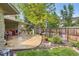Relaxing backyard patio with ample seating and a view of the green garden at 2473 S Carr Ct, Lakewood, CO 80227