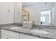 Modern bathroom with double sinks, granite countertops, and an expansive mirror at 15700 E Jamison Dr # 305, Englewood, CO 80112