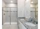 Stylish bathroom boasts a double vanity with granite countertops, and a large glass shower at 15700 E Jamison Dr # 305, Englewood, CO 80112