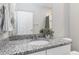 Bathroom featuring granite countertops, a white sink, and a large mirror at 15700 E Jamison Dr # 305, Englewood, CO 80112