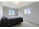 Bedroom with plush carpet, two windows, and neutral color scheme at 15700 E Jamison Dr # 305, Englewood, CO 80112