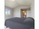 Spacious bedroom featuring carpet floors and a bathroom ensuite at 15700 E Jamison Dr # 305, Englewood, CO 80112
