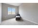 Bright bedroom offers new neutral carpet, and a comfy lounge chair next to a sunny window at 15700 E Jamison Dr # 305, Englewood, CO 80112