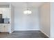 Well-lit dining room with a modern chandelier and easy access to the kitchen area at 15700 E Jamison Dr # 305, Englewood, CO 80112