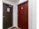 Unit 305 entrance featuring a dark brown fire door next to the unit's deep red entry door at 15700 E Jamison Dr # 305, Englewood, CO 80112