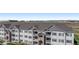 Exterior view of multi-story apartment buildings with balconies and well-maintained landscaping at 15700 E Jamison Dr # 305, Englewood, CO 80112