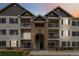 Charming condo complex with balconies, brick accents, and well-maintained landscaping at 15700 E Jamison Dr # 305, Englewood, CO 80112