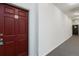 Clean hallway leading to unit 305's front door, next to the emergency exit at 15700 E Jamison Dr # 305, Englewood, CO 80112