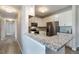 Kitchen with breakfast bar featuring granite countertops, white cabinets, and stainless steel appliances at 15700 E Jamison Dr # 305, Englewood, CO 80112