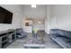 Bright living room featuring vaulted ceilings and an open floor plan with modern gray accents at 15700 E Jamison Dr # 305, Englewood, CO 80112