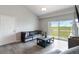 Comfortable living room features a plush gray couch, contemporary coffee table, and sliding glass doors at 15700 E Jamison Dr # 305, Englewood, CO 80112