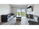 Relaxing living room complete with a gray couch, mounted tv, and sliding glass doors at 15700 E Jamison Dr # 305, Englewood, CO 80112