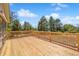 Spacious wooden backyard deck with beautiful backyard views and wooden railing at 2711 S Fenton St, Denver, CO 80227