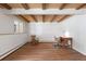 Large basement featuring a wood-beamed ceiling and laminate floors at 2711 S Fenton St, Denver, CO 80227