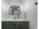 Attractive bathroom with a modern vanity, quartz countertop, custom mirror, and stylish light fixtures at 2711 S Fenton St, Denver, CO 80227