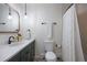 Stylish bathroom featuring modern vanity, attractive fixtures, and shower with decorative white curtain at 2711 S Fenton St, Denver, CO 80227