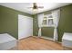 Bedroom with wooden floors, olive green walls, and ample closet space at 2711 S Fenton St, Denver, CO 80227
