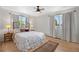 Bright bedroom with a decorative bed, hardwood floors, and bright natural light at 2711 S Fenton St, Denver, CO 80227