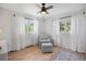 Bright bedroom with a chair and windows to let in the natural sunlight at 2711 S Fenton St, Denver, CO 80227