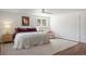Bright bedroom featuring a large bed, wooden floor, stylish rug, and a window at 2711 S Fenton St, Denver, CO 80227