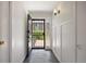 Bright entryway with slate flooring, white walls, decorative molding, and a view through the security door at 2711 S Fenton St, Denver, CO 80227