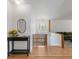 Welcoming foyer with wood floors, decorative mirror and flowers, and access to the living area at 2711 S Fenton St, Denver, CO 80227