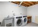 Laundry room featuring a washer, dryer, and sink at 2711 S Fenton St, Denver, CO 80227