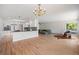 Open concept living area connecting the kitchen and living room, featuring hardwood floors and ample space at 2711 S Fenton St, Denver, CO 80227